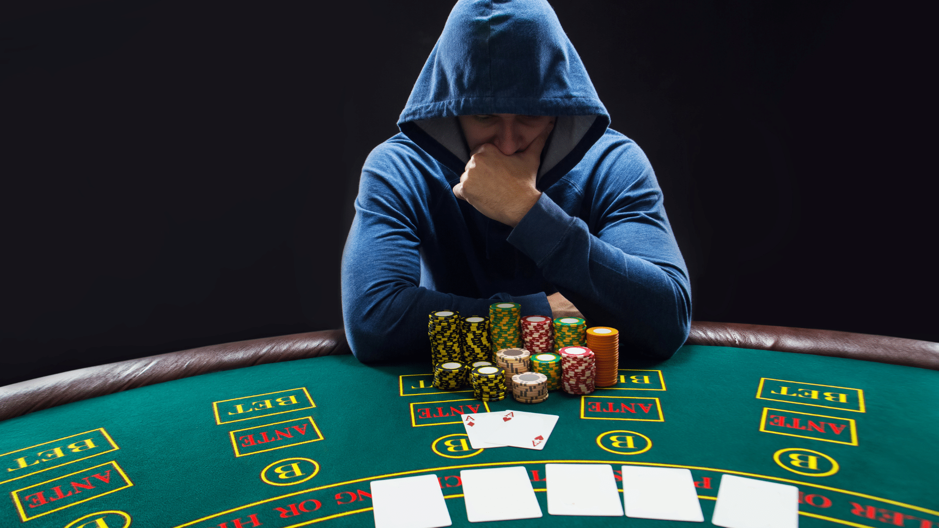 Guy playing poker and thinking
